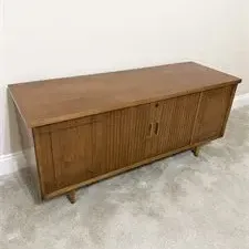 Sale Photo Thumbnail #35: Mid-century modern Lane walnut record cabinet or credenza, featuring tambour doors and tapered legs.