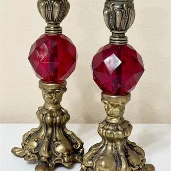 Sale Photo Thumbnail #3: Pair of vintage ornate brass candlesticks featuring large, faceted ruby red glass spheres on the stems.