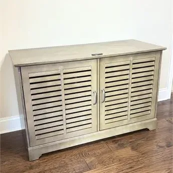Sale Photo Thumbnail #43: Contemporary wooden storage cabinet with a light gray finish, featuring two louvered doors and silver-tone metal handles.
