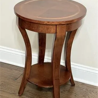 Sale Photo Thumbnail #62: Traditional round wooden accent table featuring a sunburst veneer top with a lighter wood inlay, curved legs, and a lower display shelf.