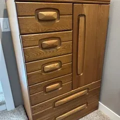 Sale Photo Thumbnail #30: Vintage oak gentleman's chest featuring four stacked drawers, a side cabinet door, and two wide bottom drawers with distinctive carved wooden pulls.
