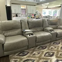 Sale Photo Thumbnail #52: Contemporary grey leather home theater seating unit featuring three reclining seats, built-in cup holders, and storage consoles.