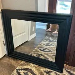 Sale Photo Thumbnail #43: Large rectangular wall mirror featuring a wide, stepped black wooden frame.