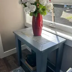 Sale Photo Thumbnail #32: Contemporary gray-painted wooden end table with a tiled top inlay, styled with a red ceramic vase of faux white roses.