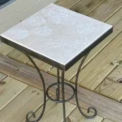 Sale Photo Thumbnail #25: Small square accent table featuring a light-colored stone or tile top on a dark wrought iron base with scrolled legs.