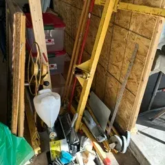 Sale Photo Thumbnail #23: Assorted construction and drywall tools, including a yellow drywall lift, a texture sprayer, and various hand tools in a storage bin.