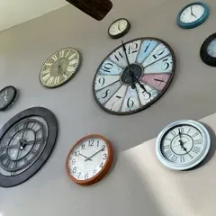Sale Photo Thumbnail #34: Collection of decorative wall clocks in various sizes, styles, and colors, including rustic, modern, and vintage-inspired designs.