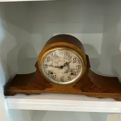 Sale Photo Thumbnail #47: Vintage Seth Thomas mantel clock in a wooden tambour case with a brass-rimmed dial, showing some wear and patina on the clock face.
