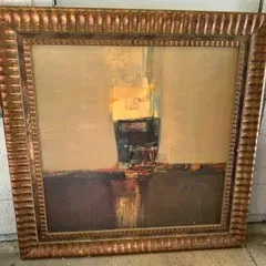 Large abstract oil painting in warm earth tones, housed in a wide, ornate fluted gold-finished frame.
