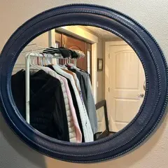 Sale Photo Thumbnail #44: Round wall mirror featuring a dark blue painted frame with beaded trim detailing.