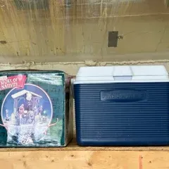 Vintage blue and white Rubbermaid cooler, shown on a shelf alongside a boxed 'The Story of the Nativity' set and a plastic owl...