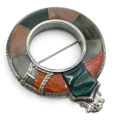 Sale Photo Thumbnail #110: Antique Scottish agate and silver garter brooch, featuring inlaid multi-colored hardstones in a circular buckle design.