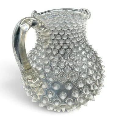 Sale Photo Thumbnail #42: Vintage Fenton clear opalescent hobnail glass pitcher, featuring a ruffled rim and applied clear handle.