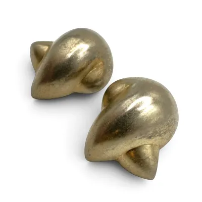 Sale Photo Thumbnail #126: Pair of vintage gold-tone clip-on earrings featuring a chunky, abstract teardrop design with a textured finish.