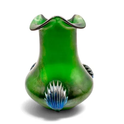 Sale Photo Thumbnail #22: Loetz-style green art glass vase featuring an iridescent finish, ruffled rim, and applied blue shell-like prunts, circa early 20th century.