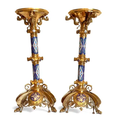 Sale Photo Thumbnail #79: Pair of ornate French Gothic Revival champlevé enamel and gilt bronze candlesticks, featuring intricate geometric patterns and winged beast feet.