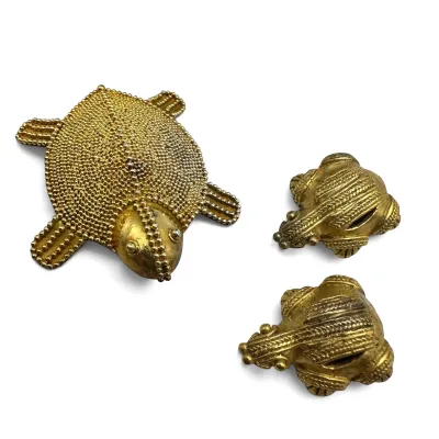 Sale Photo Thumbnail #118: Vintage gold-tone metal animal figurines, featuring a beaded turtle and two textured frogs.