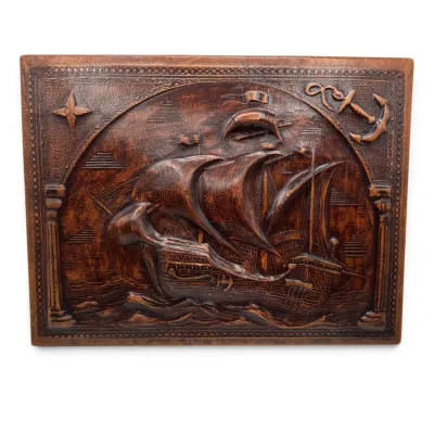 Sale Photo Thumbnail #93: Vintage embossed leather wall plaque depicting a Spanish galleon at sea, featuring a compass rose and anchor motif in the corners.