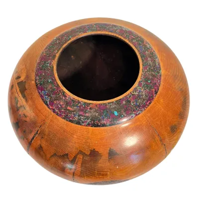 Sale Photo Thumbnail #51: Hand-turned wooden vessel featuring a wide rim inlaid with colorful crushed stone and mineral fragments, showcasing natural wood grain and rustic cracking.