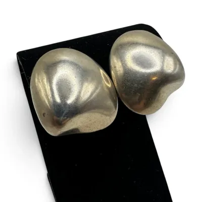 Sale Photo Thumbnail #136: Pair of vintage sterling silver clip-on earrings featuring a chunky, organic freeform design with a polished finish.
