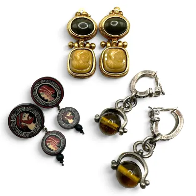 Sale Photo Thumbnail #121: Three pairs of vintage clip-on earrings, including gold-tone cameo dangles, silver-tone dangles with tiger's eye style beads, and Greek key motif portrait dangles.