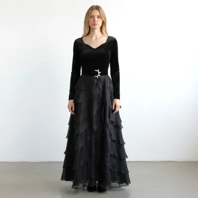 Sale Photo Thumbnail #172: Carolina Herrera Vintage black formal gown featuring a long-sleeve velvet bodice, a sweetheart neckline, a rhinestone-buckled belt, and a tiered, ruffled chiffon maxi skirt.