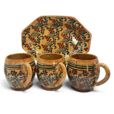 Sale Photo Thumbnail #8: Hand-painted studio art pottery set featuring three rounded mugs and an octagonal serving platter, decorated with a rustic berry and vine motif in warm earth tones.