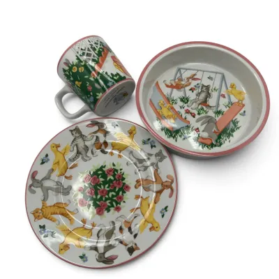 Sale Photo Thumbnail #17: Tiffany & Co. three-piece porcelain children's set, featuring a mug, bowl, and plate decorated with playful illustrations of animals in a garden.