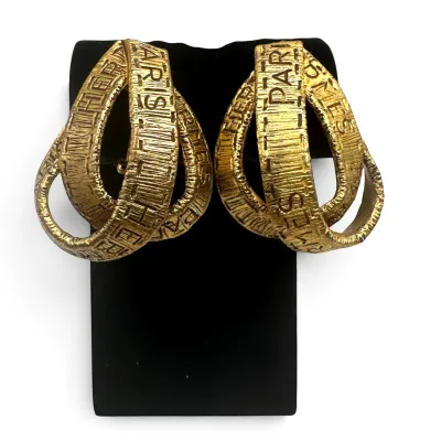Sale Photo Thumbnail #147: Vintage Hermès Paris gold-plated ribbon hoop earrings, featuring a textured finish with embossed brand lettering.