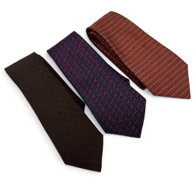 Sale Photo Thumbnail #164: Hermes Three vintage silk neckties featuring geometric and textured patterns in shades of brown, navy blue with red, and red with gold.