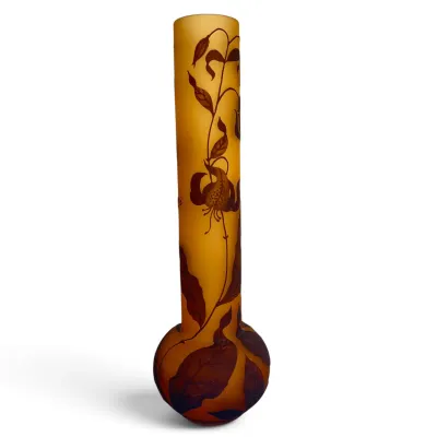 Sale Photo Thumbnail #36: Art Nouveau style cameo glass vase featuring a long, slender neck and bulbous base, decorated with a brown floral and leaf motif on a frosted amber background.
