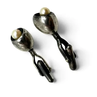 Sale Photo Thumbnail #156: Vintage sterling silver cufflinks featuring a modernist tulip design set with cultured pearls, showing a natural aged patina.