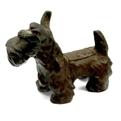 Sale Photo Thumbnail #89: Vintage cast iron Scottish Terrier figurine with a textured dark finish, featuring a raised rectangular detail on its back.