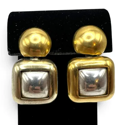 Sale Photo Thumbnail #128: Vintage two-tone clip-on earrings featuring a gold-tone dome top and a square dangle with a silver-tone center, showing some light wear.
