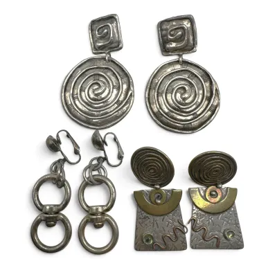 Sale Photo Thumbnail #122: Three pairs of vintage modernist silver-tone earrings, featuring spiral and geometric designs with clip-on and post backings.