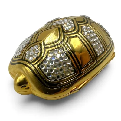 Sale Photo Thumbnail #117: Vintage gold-tone metal turtle trinket box featuring a hinged shell accented with rhinestones.