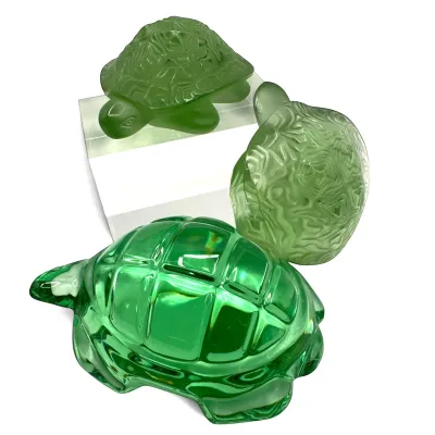 Sale Photo Thumbnail #29: Trio of green art glass turtle figurines, featuring two frosted glass turtles with textured shells and one larger polished green glass turtle.