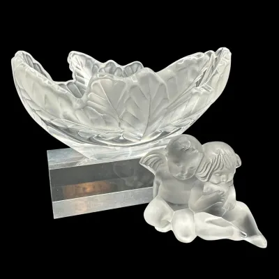 Sale Photo Thumbnail #27: Lalique frosted crystal leaf-motif bowl on a clear rectangular base, paired with a frosted crystal figurine of two seated cherubs.