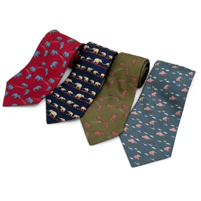 Sale Photo Thumbnail #159: Hermes Four silk neckties featuring whimsical elephant patterns in red, navy blue, olive green, and slate blue.