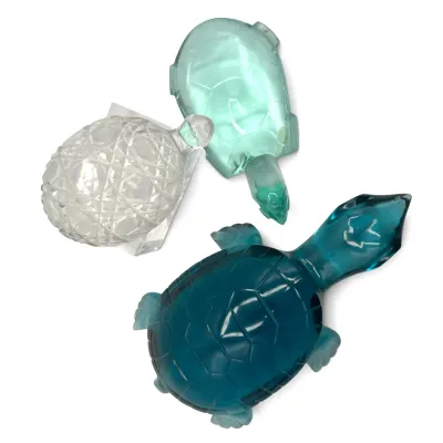 Sale Photo Thumbnail #26: Trio of vintage glass turtle figurines, including a cut crystal turtle and two molded glass turtles in shades of teal and light green.