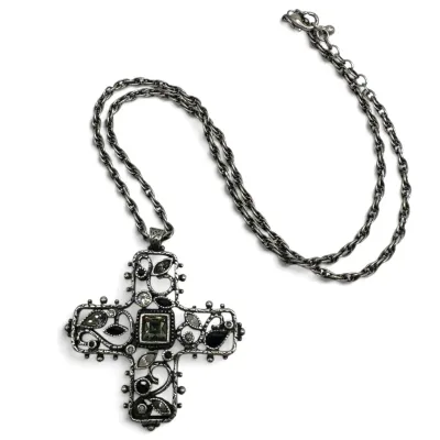 Sale Photo Thumbnail #113: Gothic-style silver-tone cross pendant necklace featuring intricate openwork filigree, set with black and clear rhinestones on a matching link chain.