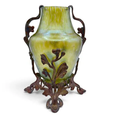 Sale Photo Thumbnail #23: Art Nouveau iridescent green glass vase cradled in an ornate, footed bronze or spelter metal mount with organic leaf and berry motifs.
