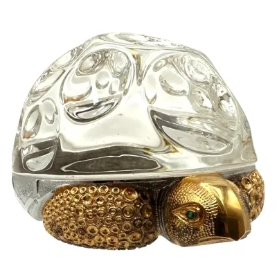 Sale Photo Thumbnail #32: Vintage Steuben crystal and gilt metal turtle figurine, featuring a textured sterling silver body with green rhinestone eyes and a heavy molded clear crystal shell.