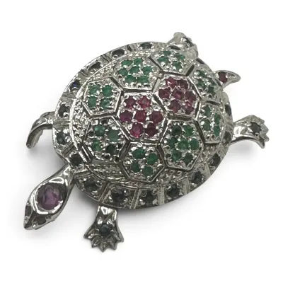 Sale Photo Thumbnail #116: Vintage sterling silver turtle brooch featuring a shell set with green, red, and dark blue gemstones.