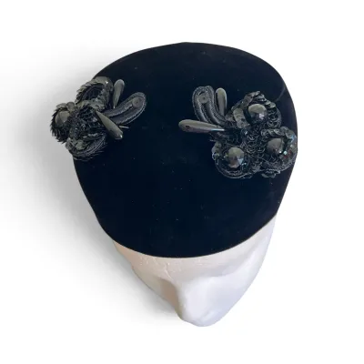 Sale Photo Thumbnail #167: Vintage mid-century black velvet pillbox hat adorned with intricate black sequin, bead, and cord appliques.