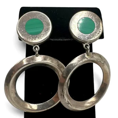Sale Photo Thumbnail #119: Vintage sterling silver dangle earrings featuring a circular post with a green malachite inlay and a large, hollow hoop drop.