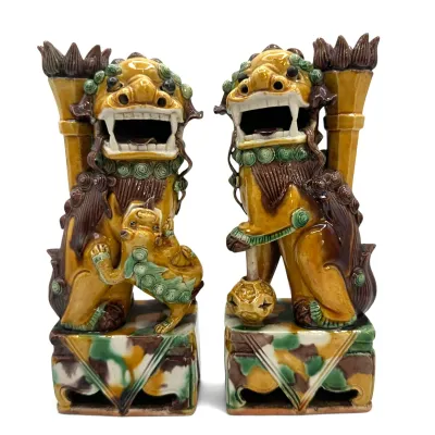 Sale Photo Thumbnail #75: Pair of Chinese Sancai-glazed ceramic Foo Dog joss stick holders, featuring a male with a globe and a female with a pup, finished in traditional amber, green, and brown glazes.