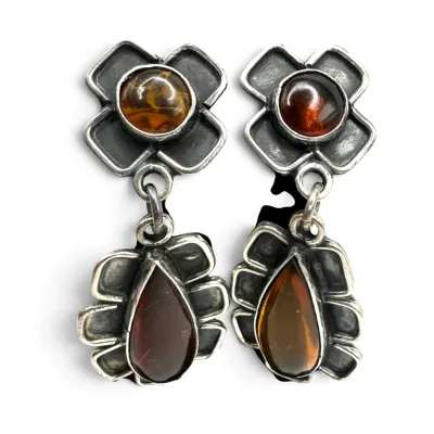Sale Photo Thumbnail #133: Vintage sterling silver and amber dangle earrings, featuring round and teardrop-shaped amber cabochons set in stylized floral and geometric frames.