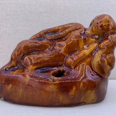 Sale Photo Thumbnail #297: Antique 19th Century Yellow Ware Reclining Boy Larkin Brothers Pottery Figural Inkwell