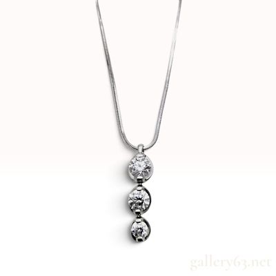 Sale Photo Thumbnail #340: Trilogy Platinum and 1.01 Carat Diamond Three Stone Pendant Necklace